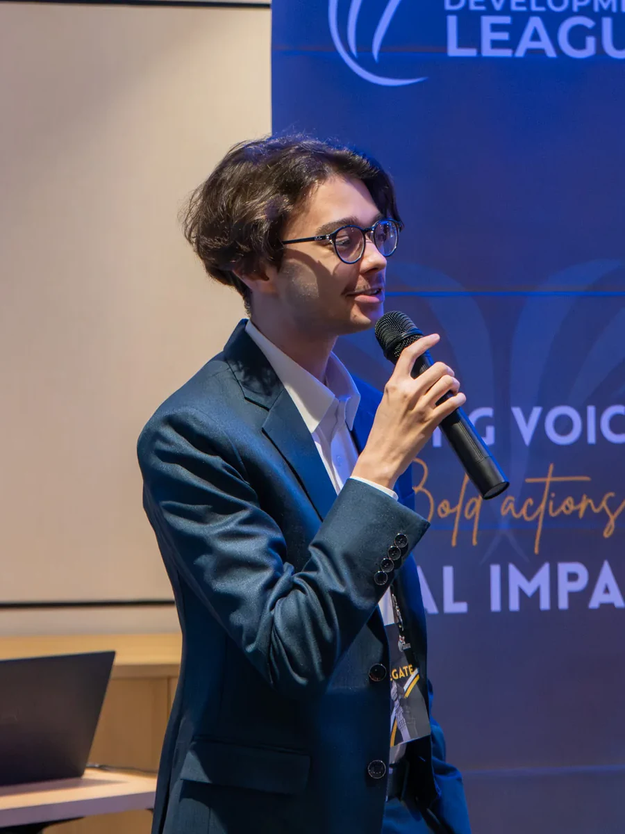 Sami Fathi speaking into a microphone at an event